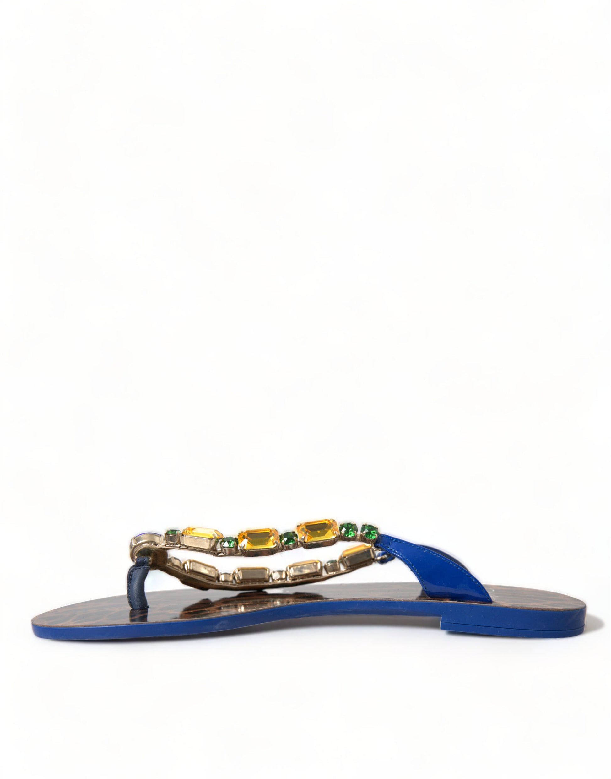 Blue patent leather thong sandals with gold-tone accents, embellished with yellow and green crystals on the strap.