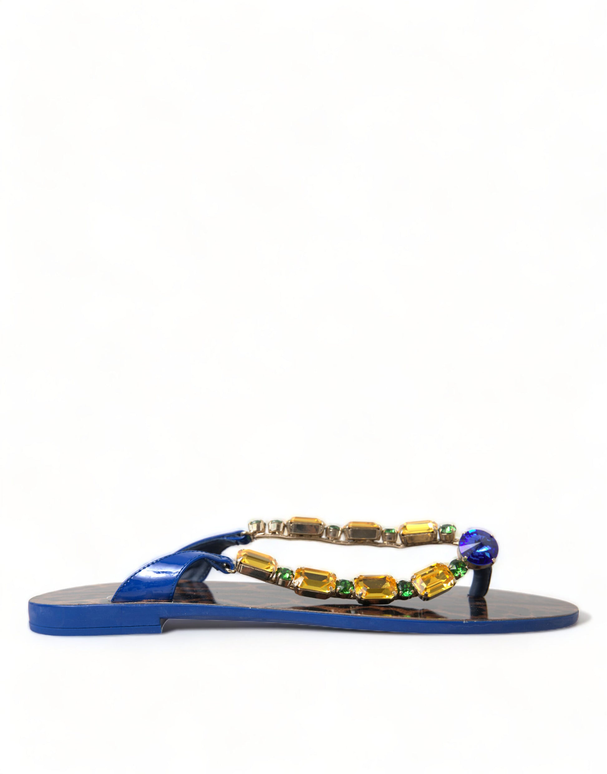 Dolce & Gabbana blue patent thong sandals with gold-tone accents, embellished with large yellow and blue crystals.