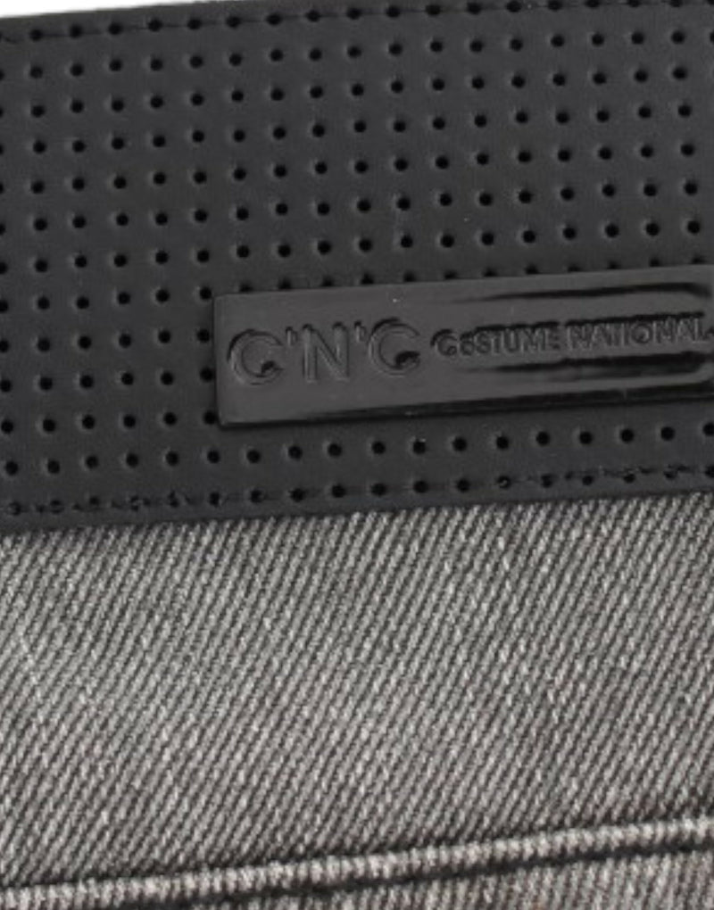 Gray denim jeans with a black perforated leather waistband and C'N'C Costume National logo patch