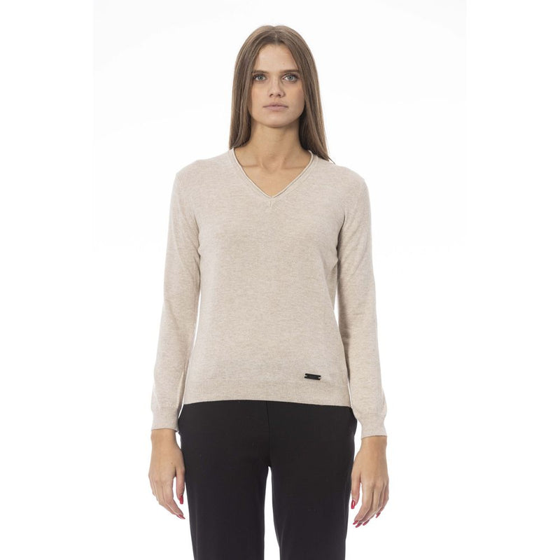 Beige V-neck polyamide women sweater with long sleeves and ribbed hem worn with black trousers