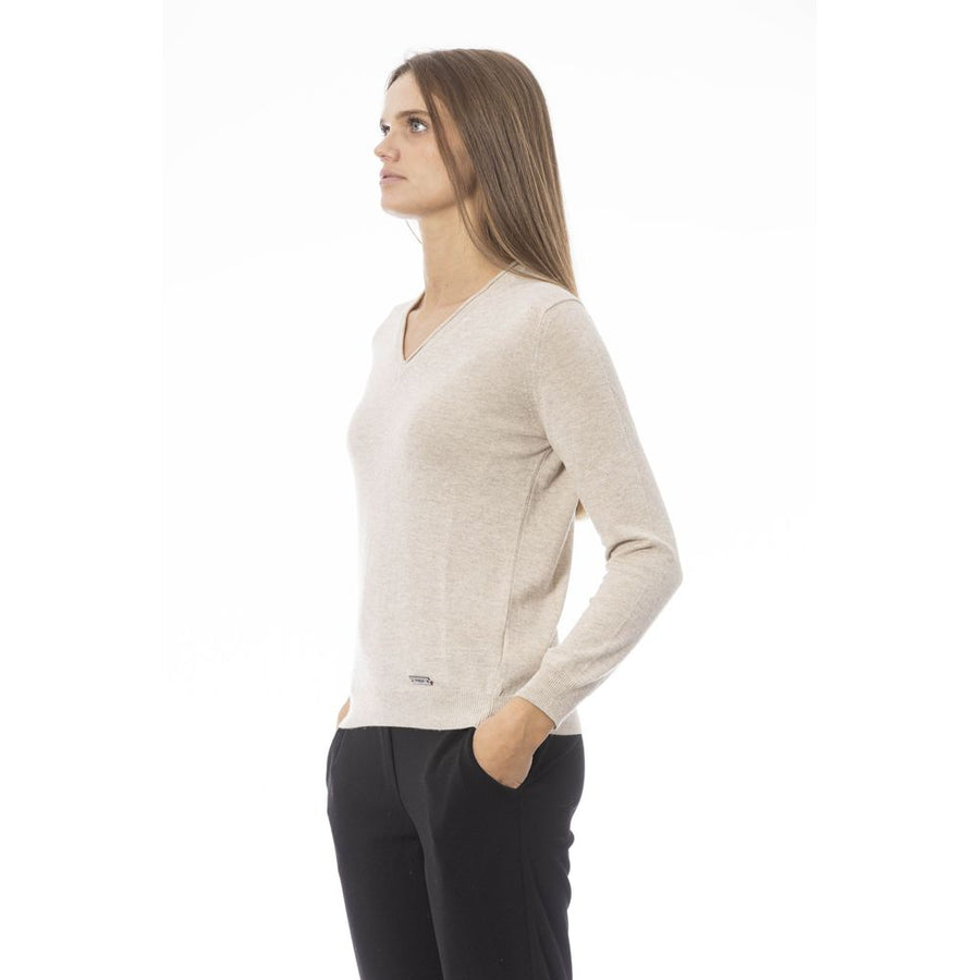 Beige V-neck polyamide women sweater with long sleeves and ribbed hem worn with black trousers