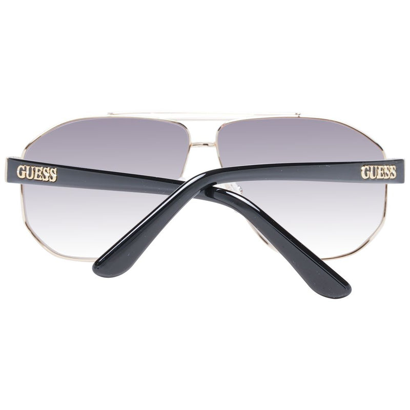 Gold metal aviator sunglasses with black temples and gradient grey lenses, featuring the Guess logo
