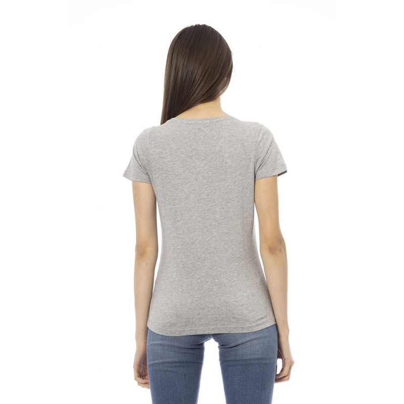 Back view of a woman wearing a gray cotton short-sleeve t-shirt and blue jeans