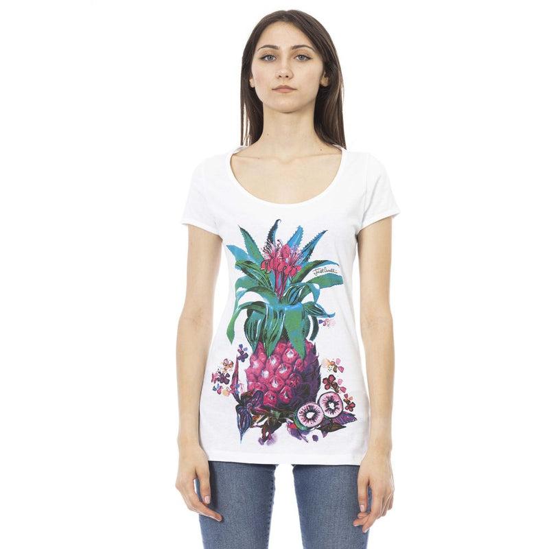 A woman wearing a white cotton t-shirt with a colorful pineapple and floral graphic on the front