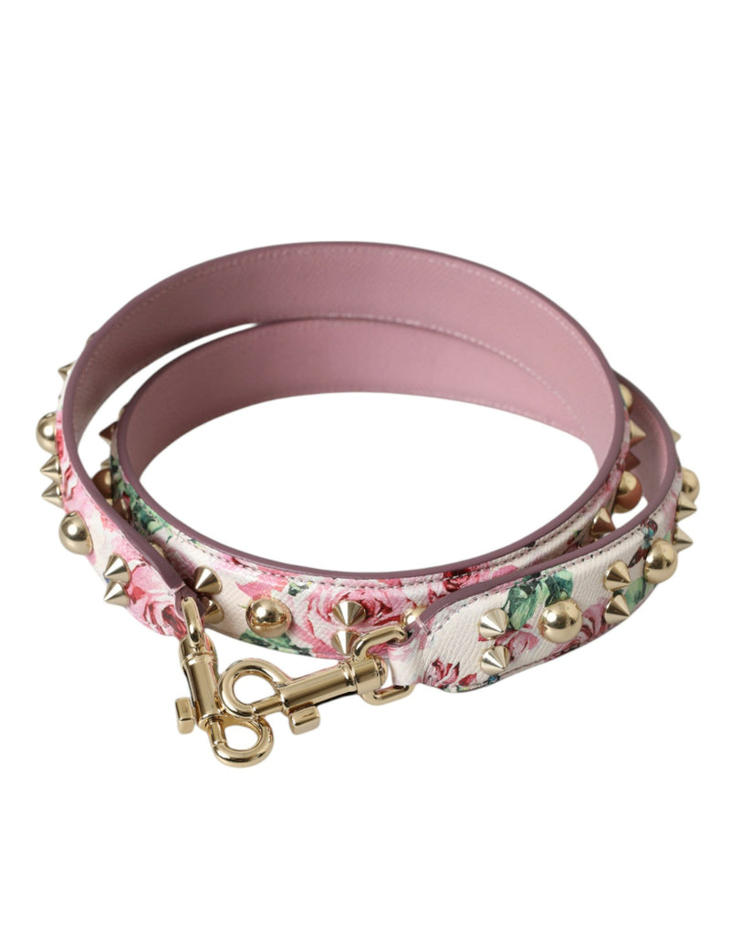 Coiled pink leather handbag shoulder strap with a floral print and gold studs and clasps