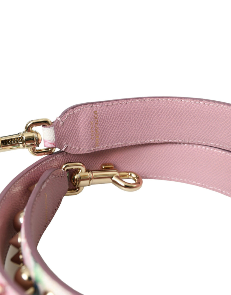 Pink leather shoulder strap with gold hardware and floral accents