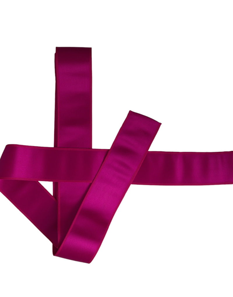 Fuchsia pink silk waist belt folded on white background