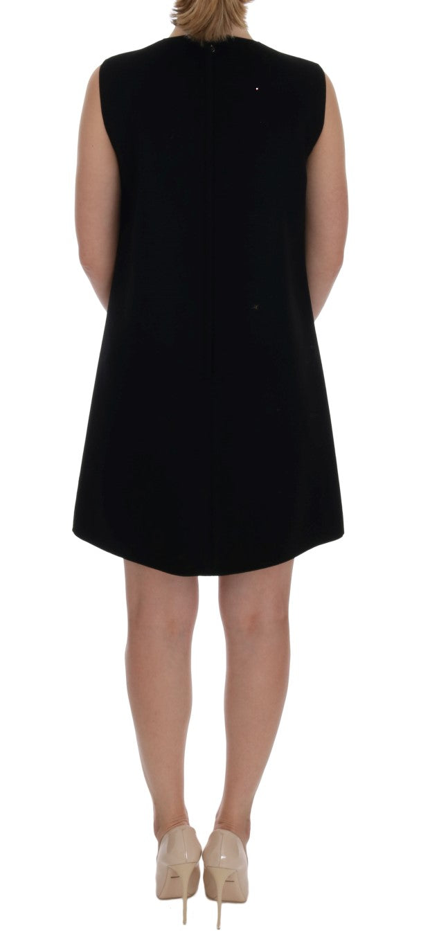 Black sleeveless shift dress in a minimalist style, shown from the back