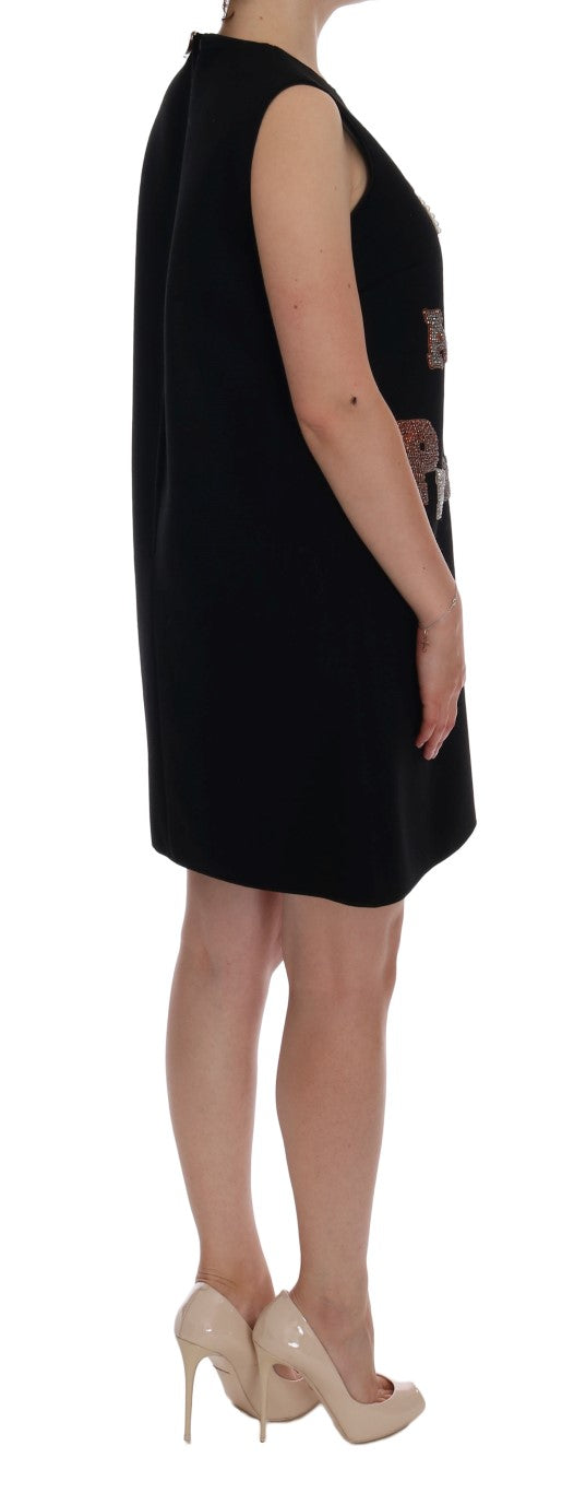 Black sleeveless shift dress with crystal text embellishments on the side