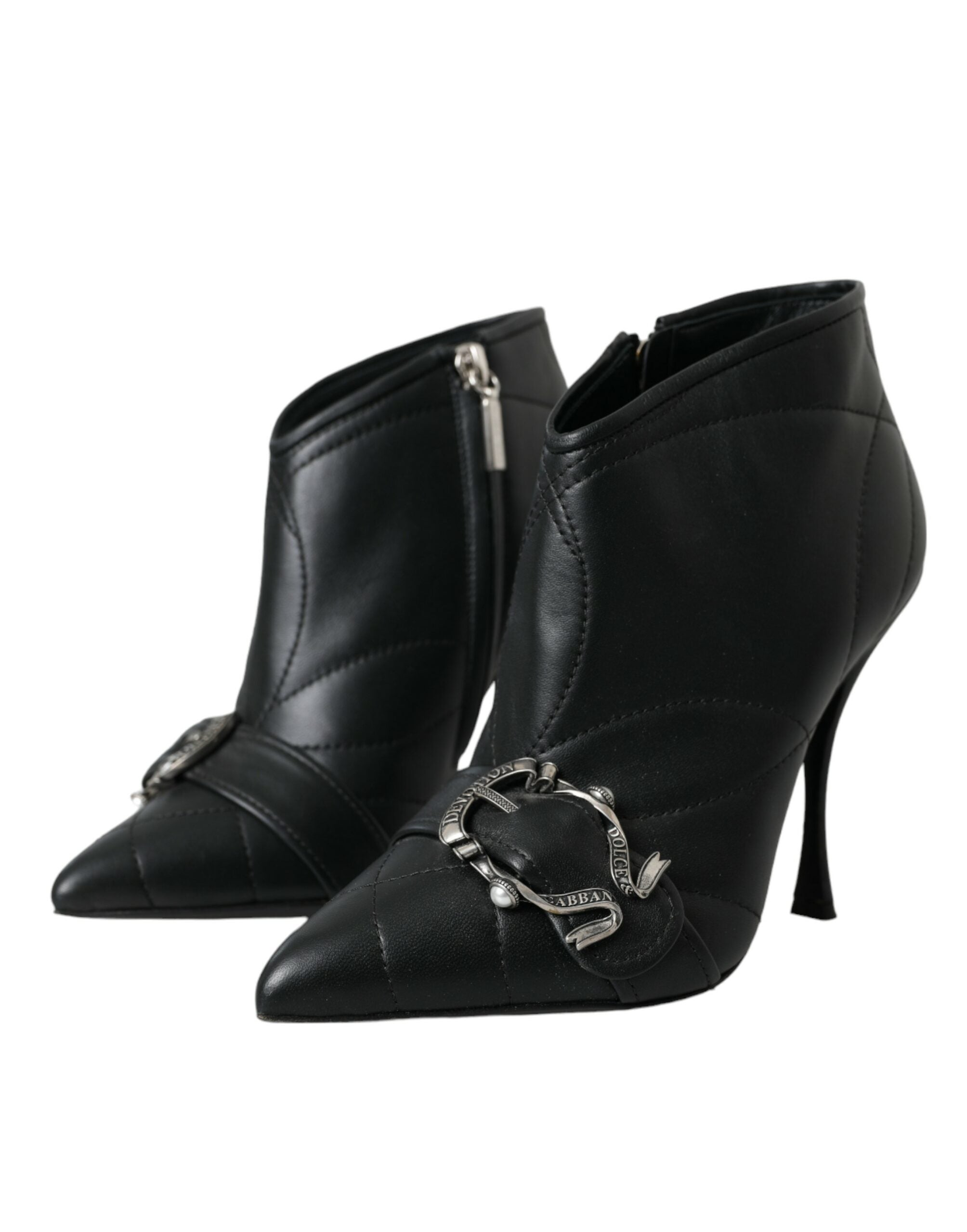 Black quilted leather ankle boots with pointed toes, stiletto heels, and ornate silver buckle embellishments.