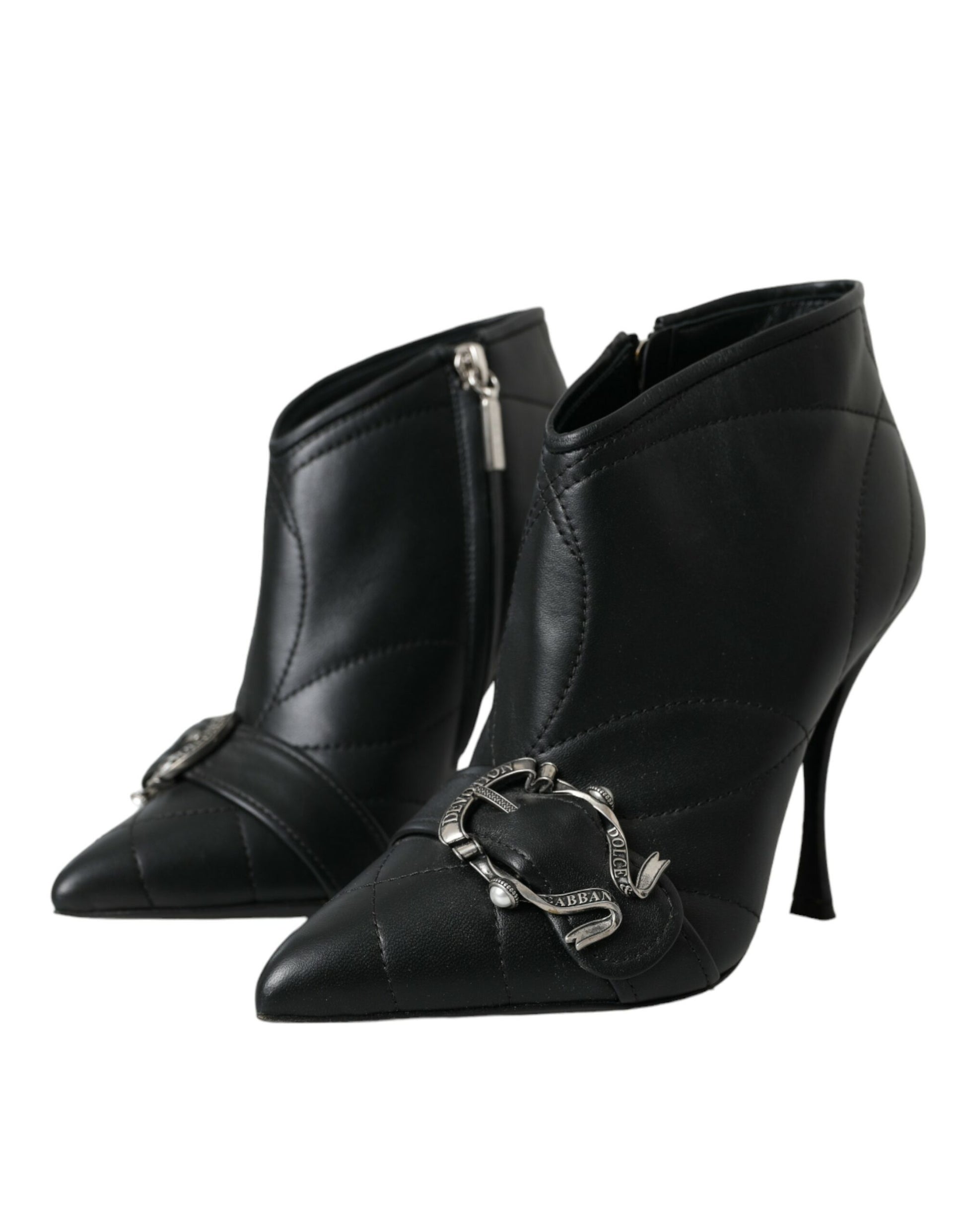 Black quilted leather ankle boots with pointed toes, stiletto heels, and ornate silver buckle embellishments.