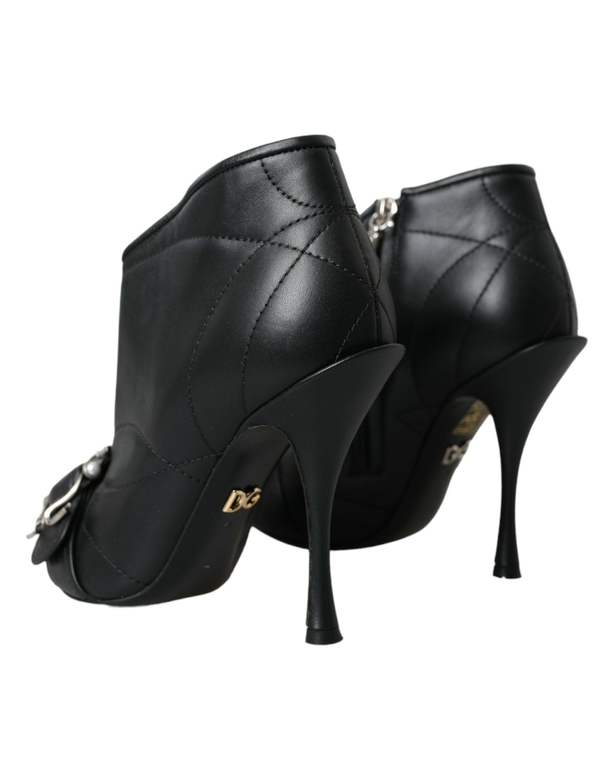 Black quilted leather Dolce & Gabbana stiletto ankle boots with gold DG logo and front buckle detail.