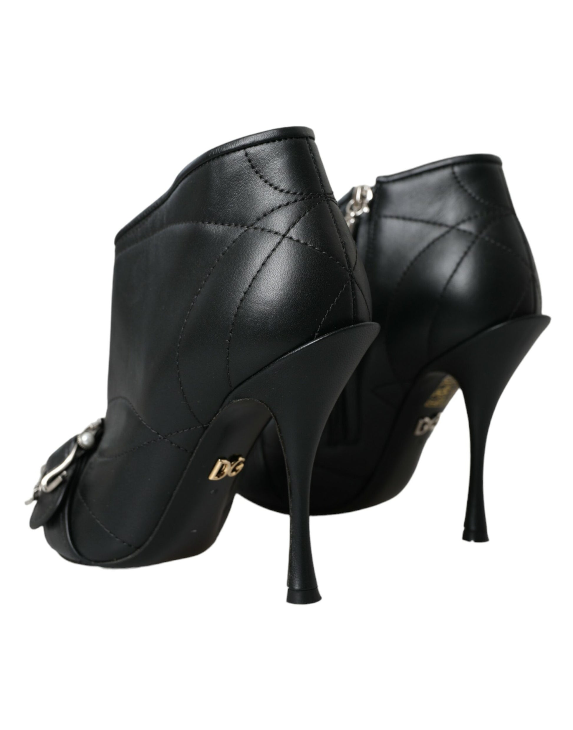 Black quilted leather Dolce & Gabbana stiletto ankle boots with gold DG logo and front buckle detail.