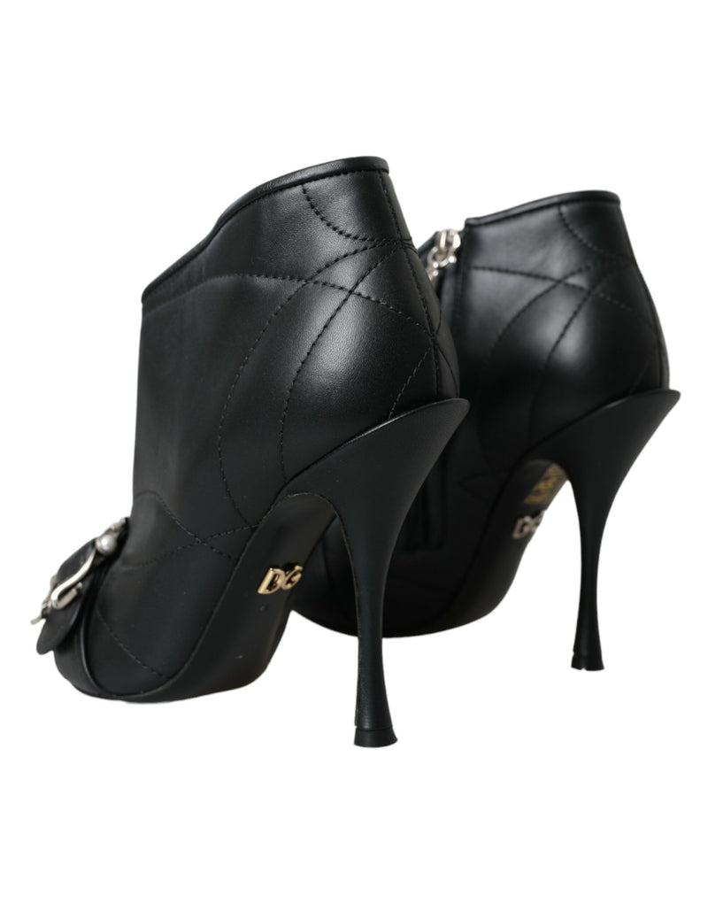 Black quilted leather Dolce & Gabbana stiletto ankle boots with gold DG logo and front buckle detail.