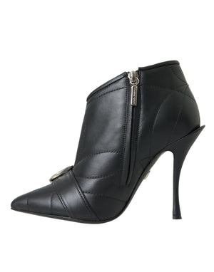 Black quilted leather Dolce & Gabbana stiletto ankle boot with pointed toe, side zipper, and buckled strap detail.