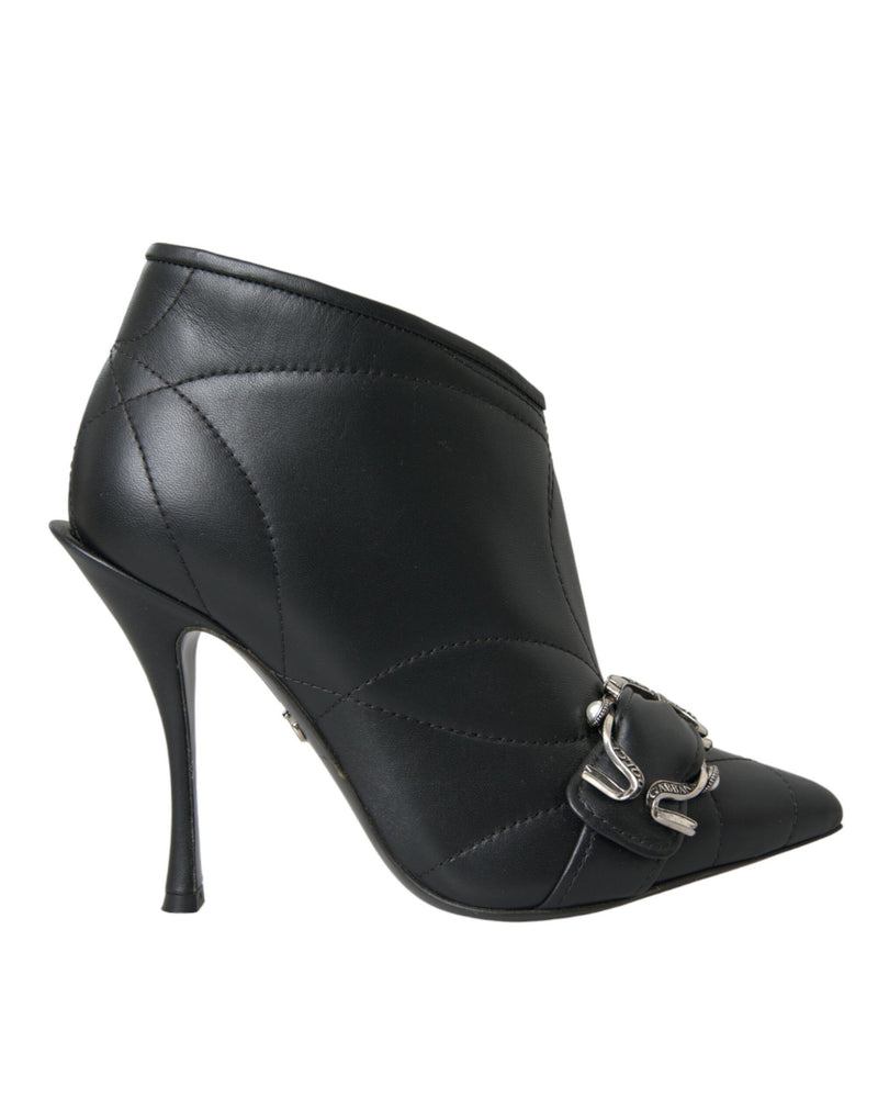 Black quilted leather stiletto ankle boot with pointed toe and decorative silver buckle detail.