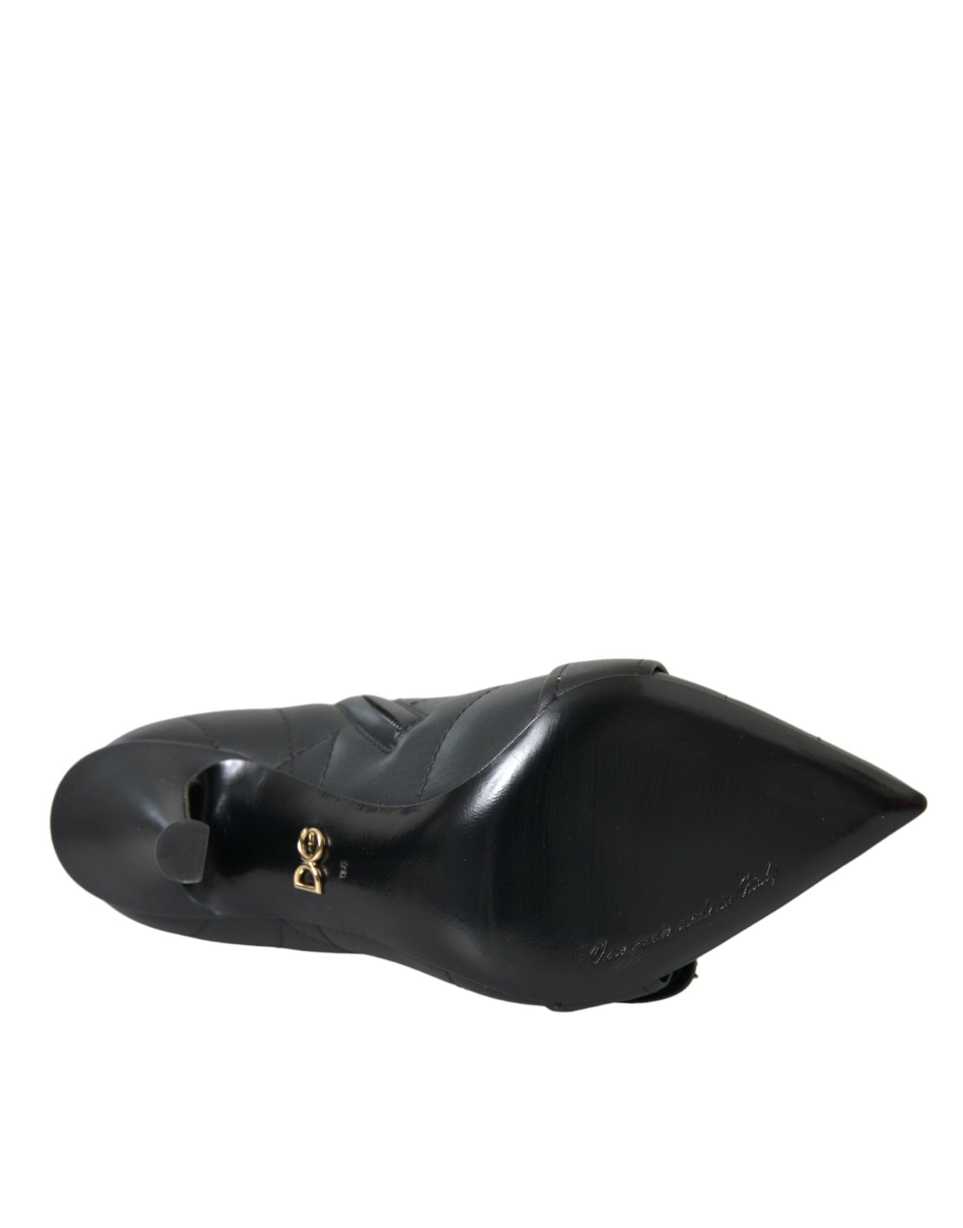 Black quilted leather Dolce & Gabbana stiletto ankle boot with pointed toe and gold DG logo on the sole.