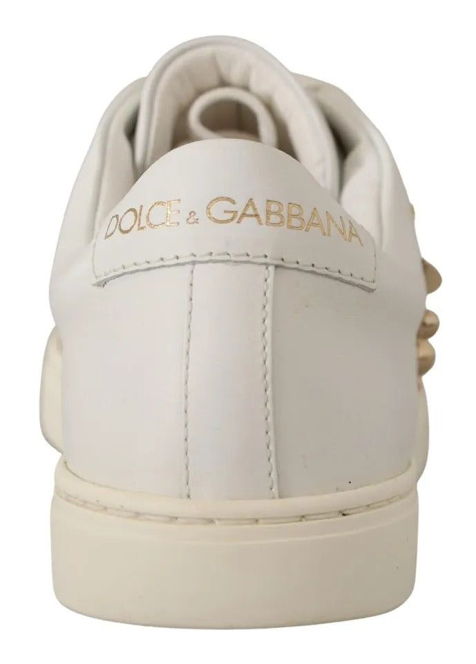 White leather Dolce & Gabbana low-top sneaker, back view, featuring gold logo lettering on the heel tab.