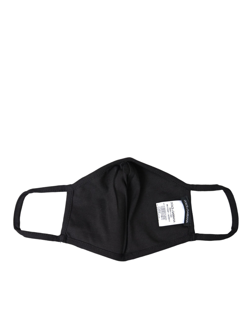 Black fabric face mask with elastic ear straps and interior brand label