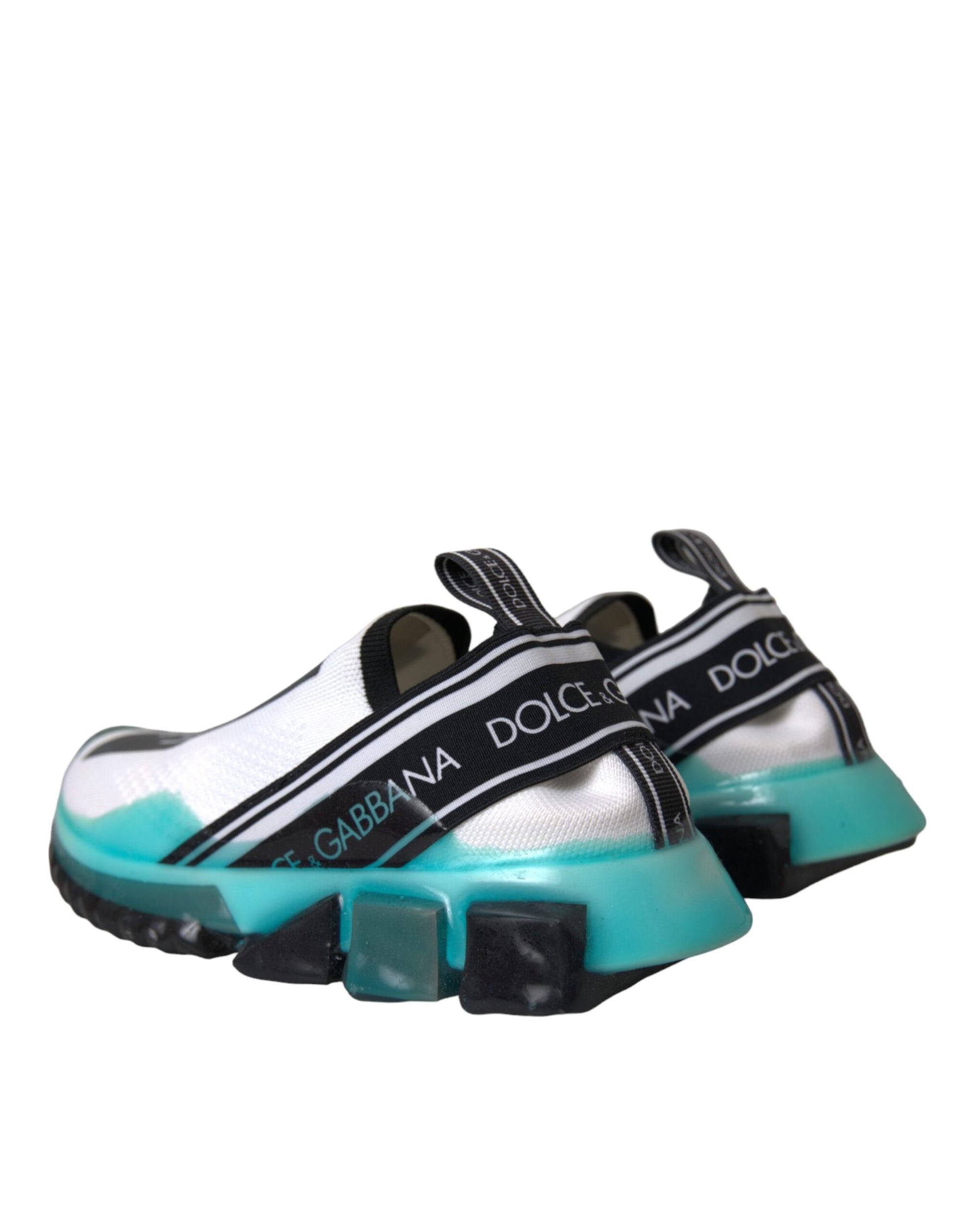 Dolce & Gabbana Sorrento slip-on sneakers in white knit with blue accents, black branded straps, and chunky black soles.