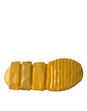 Bright yellow rubber sneaker sole with chunky, ribbed design and smooth geometric heel blocks.