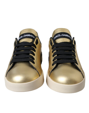 Metallic gold calf leather Dolce & Gabbana Portofino sneakers with black laces and a white rubber sole.