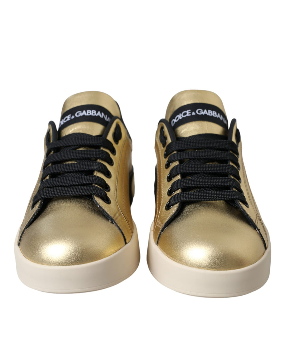 Metallic gold calf leather Dolce & Gabbana Portofino sneakers with black branding and white rubber soles.