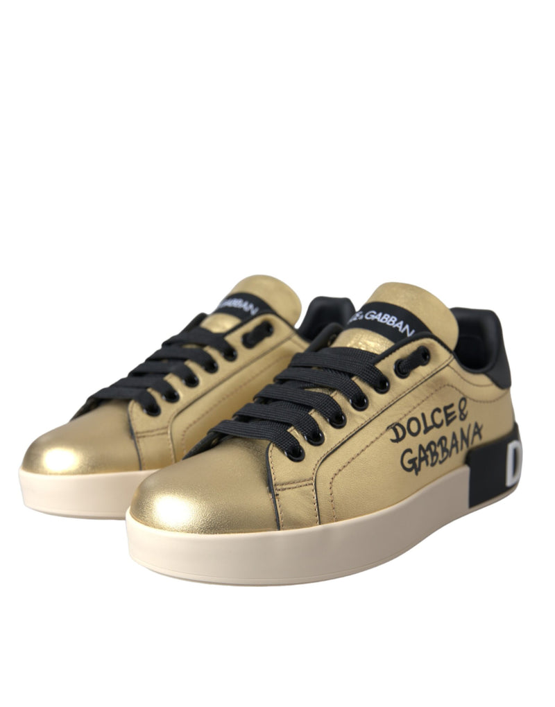 Metallic gold calf leather Dolce & Gabbana Portofino sneakers with black laces, logo branding, and a thick white sole.