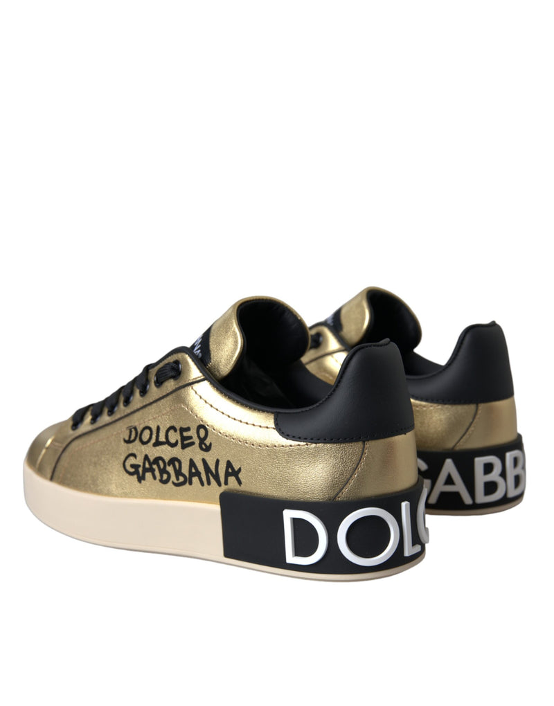 Gold metallic calf leather Dolce & Gabbana low-top sneakers with black branded heel tabs and thick white rubber soles.
