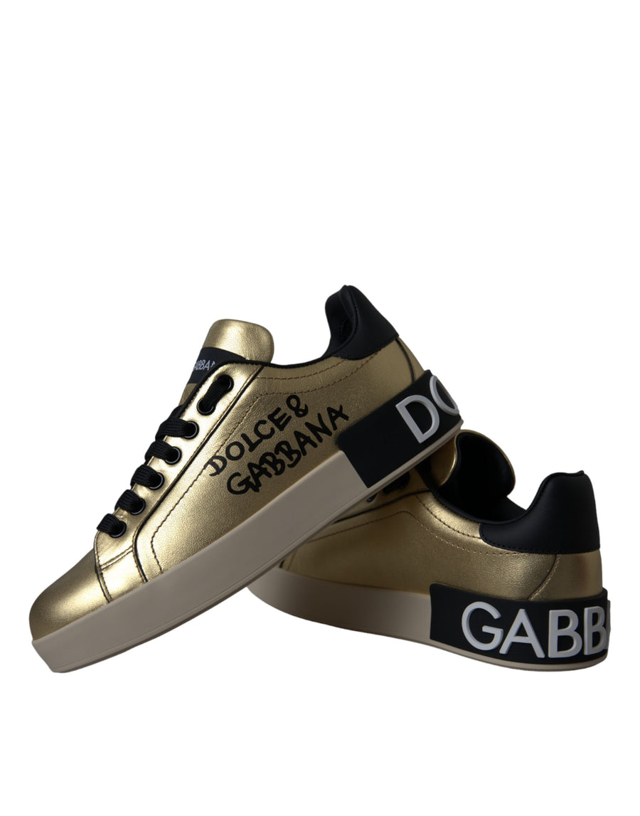 Metallic gold calf leather Dolce & Gabbana Portofino sneakers with black branding and white rubber soles.