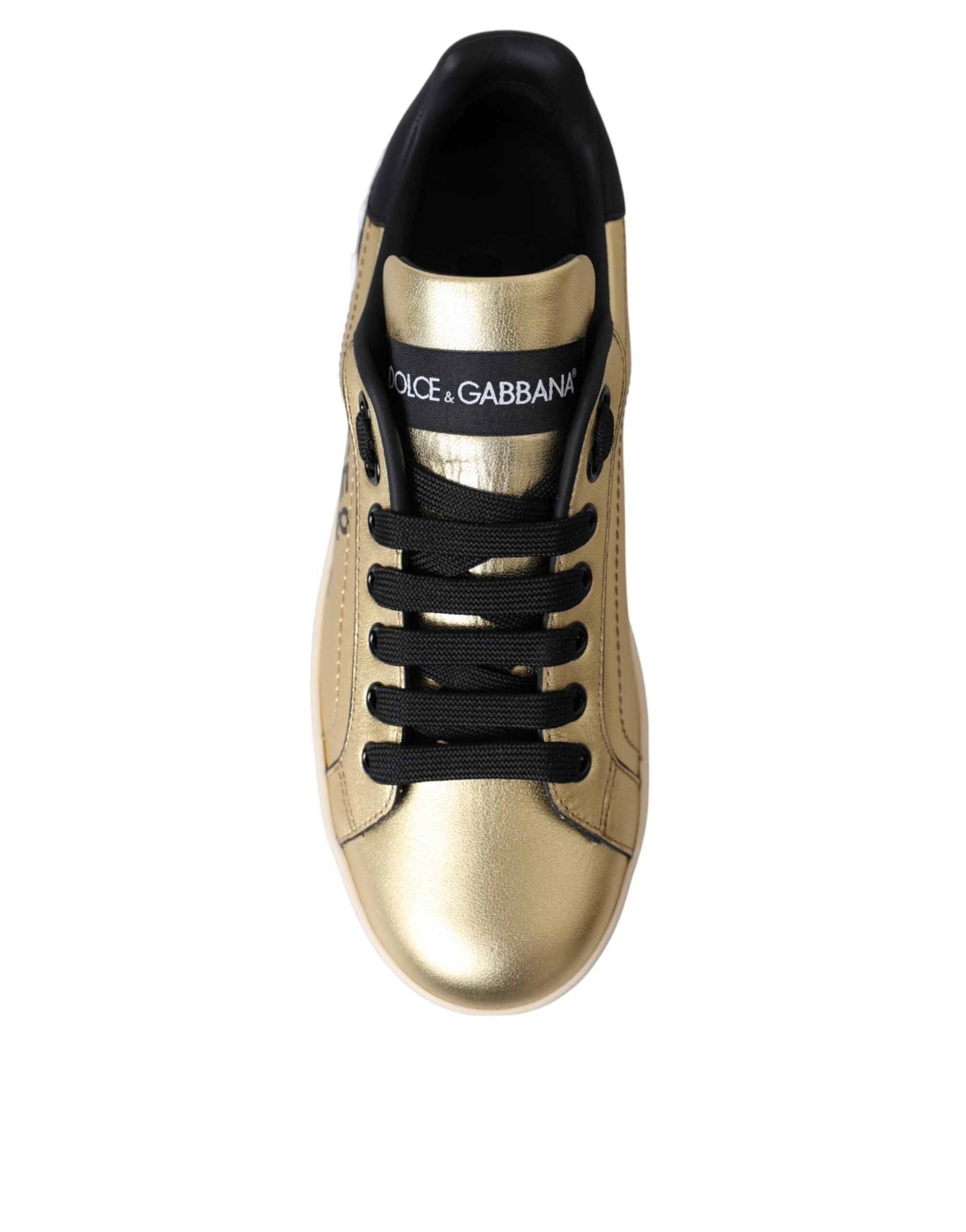 Dolce & Gabbana gold metallic calf leather Portofino sneakers with black laces and tongue logo patch.