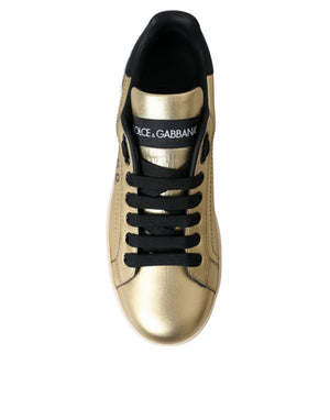 Dolce & Gabbana gold metallic calf leather Portofino sneakers with black laces and tongue logo patch.