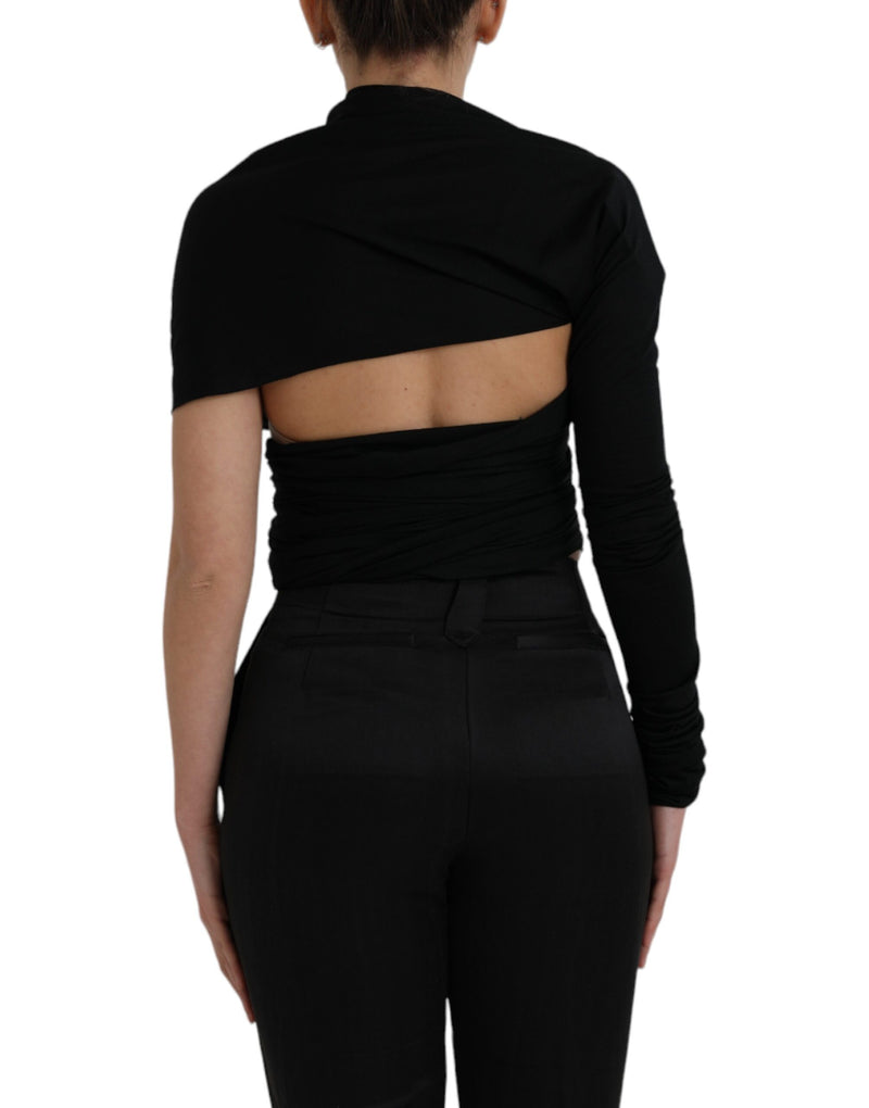 Black wool asymmetric long sleeve top with back cutout worn with black pants