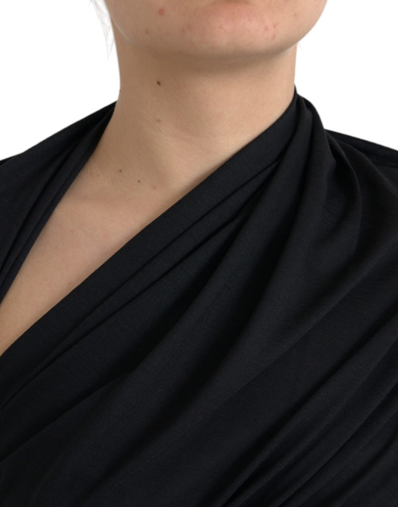 Black wool asymmetric draped top worn by a person