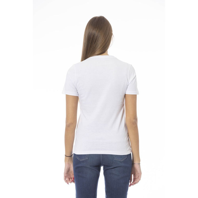 Woman wearing a plain white cotton short sleeve t-shirt paired with blue jeans seen from behind