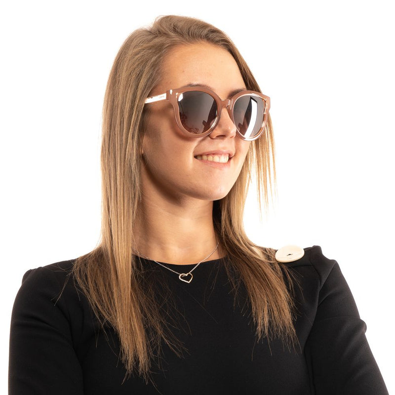 Brown plastic and metal round sunglasses worn by a woman
