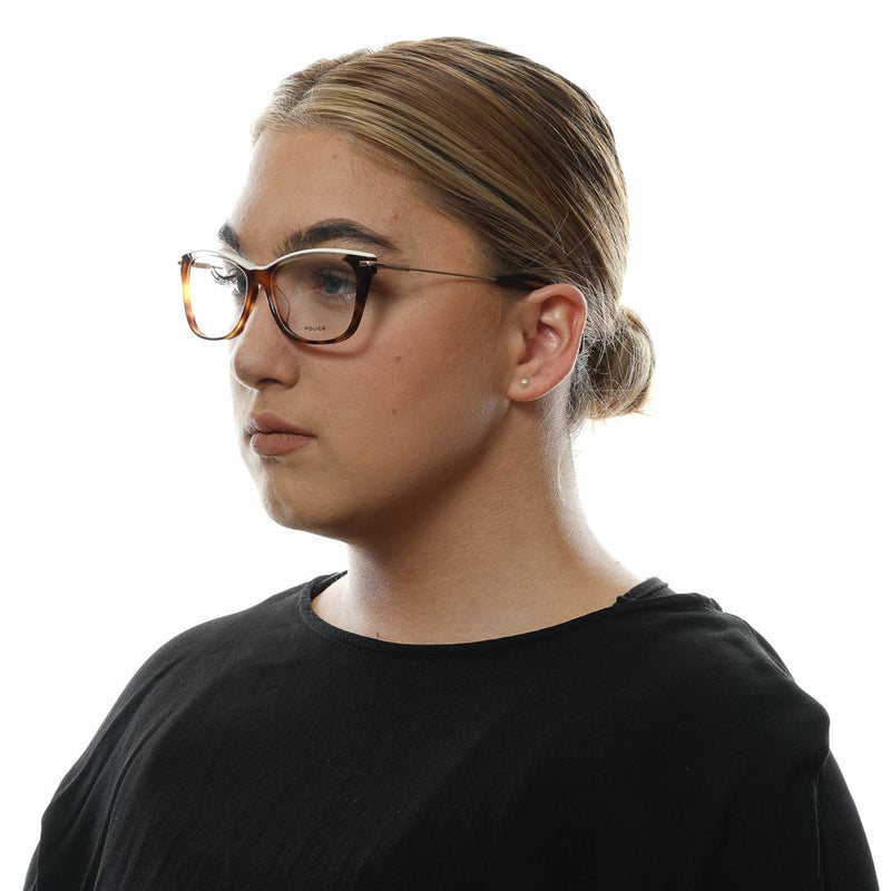 Tortoise shell brown and gold plastic and metal cat-eye eyeglass frames worn by a person