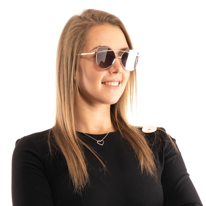 Guess rose gold metal sunglasses with tinted lenses worn by a smiling woman