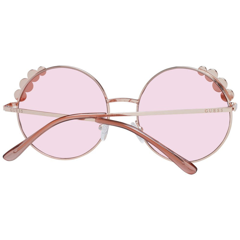Round rose gold metal sunglasses with pink lenses and decorative scalloped frame details