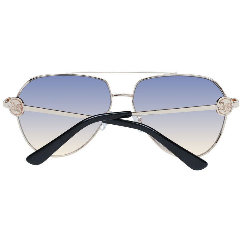 Guess aviator sunglasses with gold metal frames, gradient blue-to-yellow lenses, and black temple tips