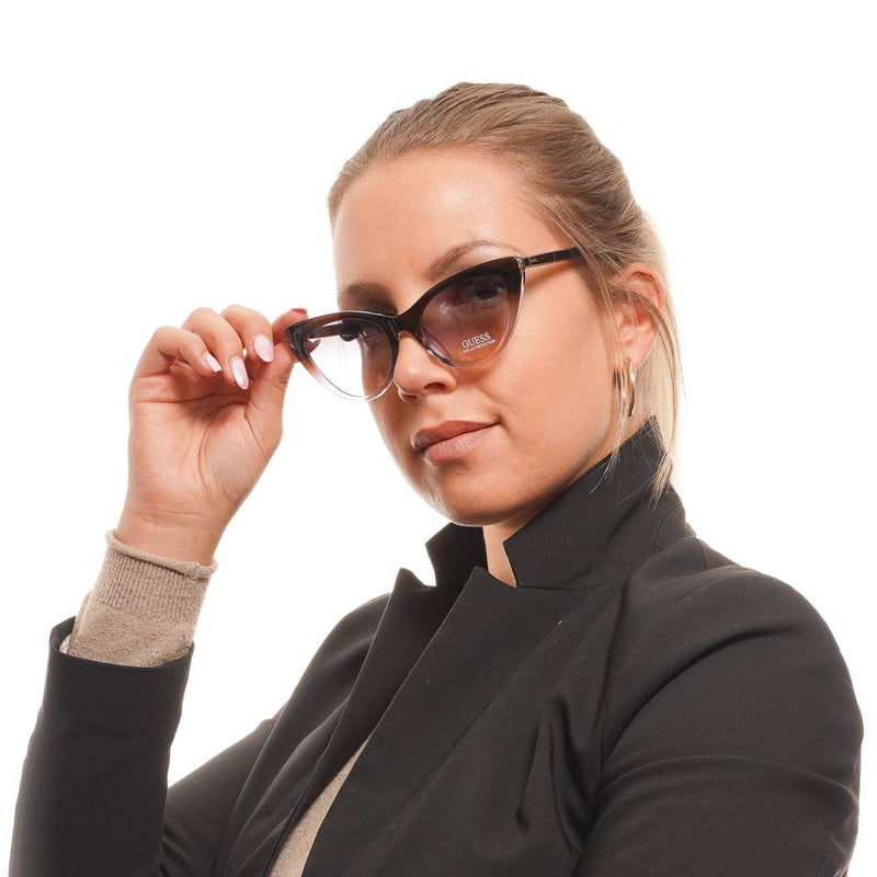 Guess brown plastic cat-eye sunglasses with gradient lenses worn by a woman