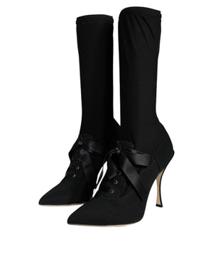 Black Dolce & Gabbana mid-calf sock boots in stretch fabric with pointed toes, stiletto heels, and silk ribbon laces.