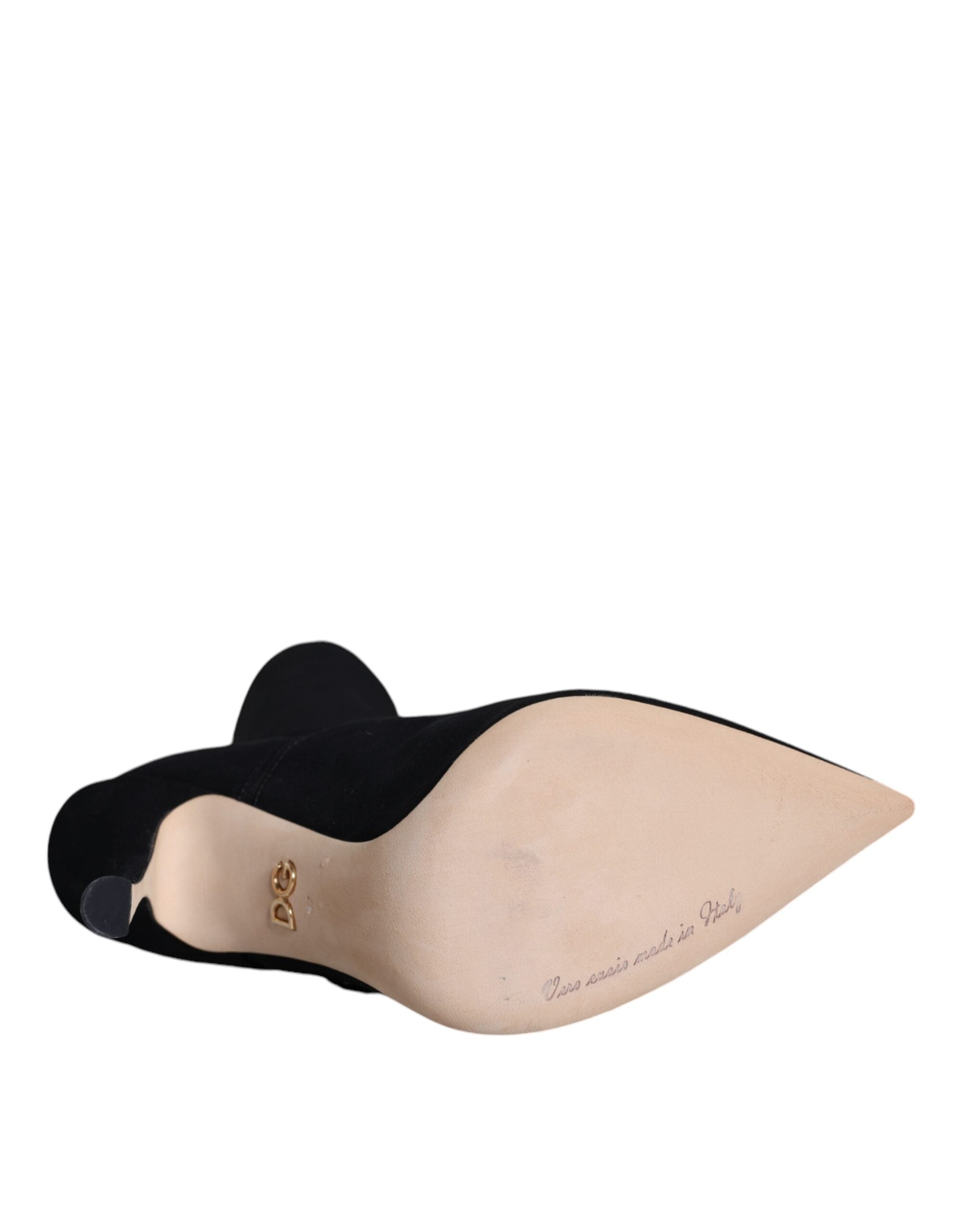 Dolce & Gabbana black suede mid-calf stiletto boots featuring a pointed toe and tan leather sole with gold DG logo.