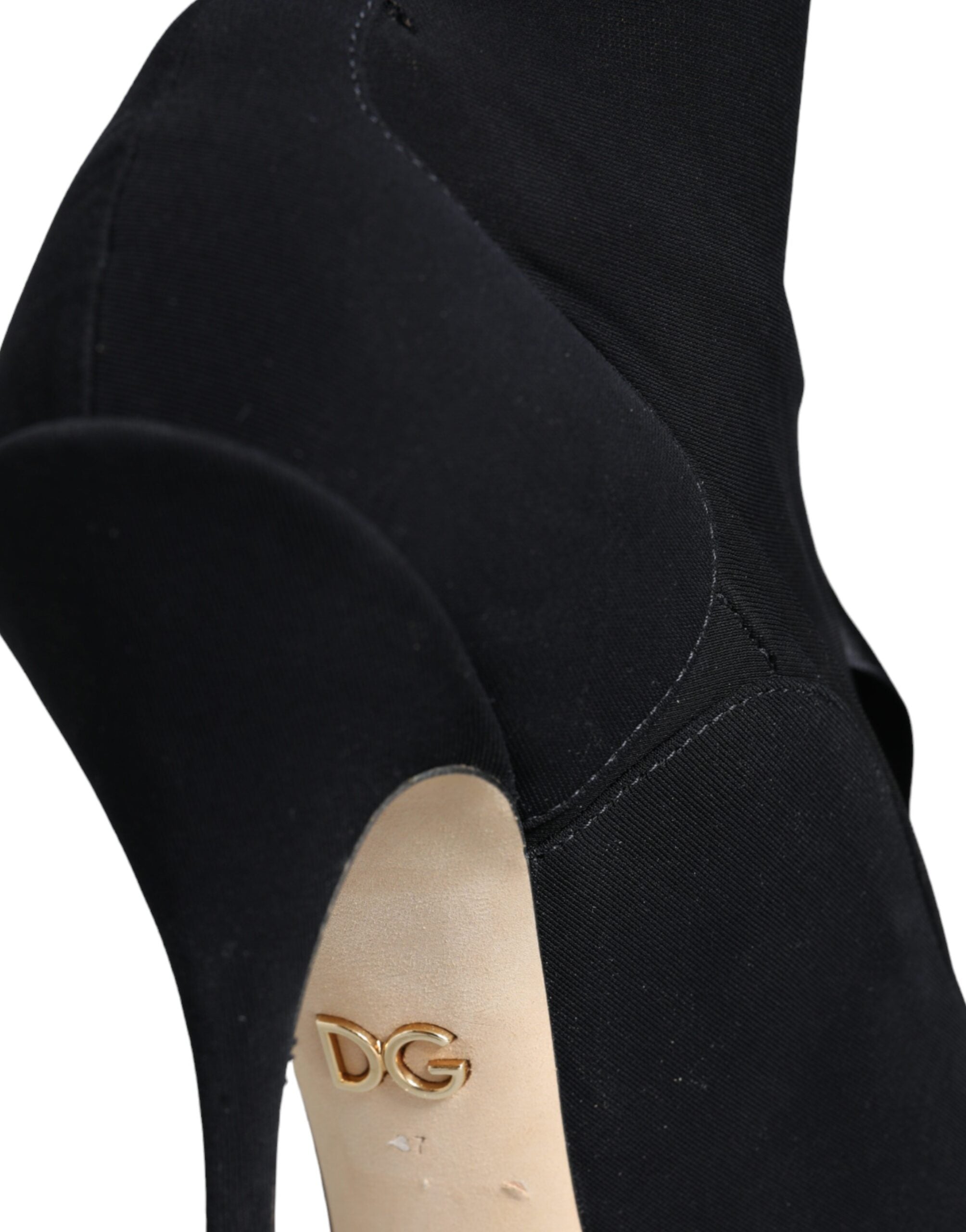 Dolce & Gabbana black stretch fabric mid-calf stiletto boots with gold metal DG logo on the beige sole.