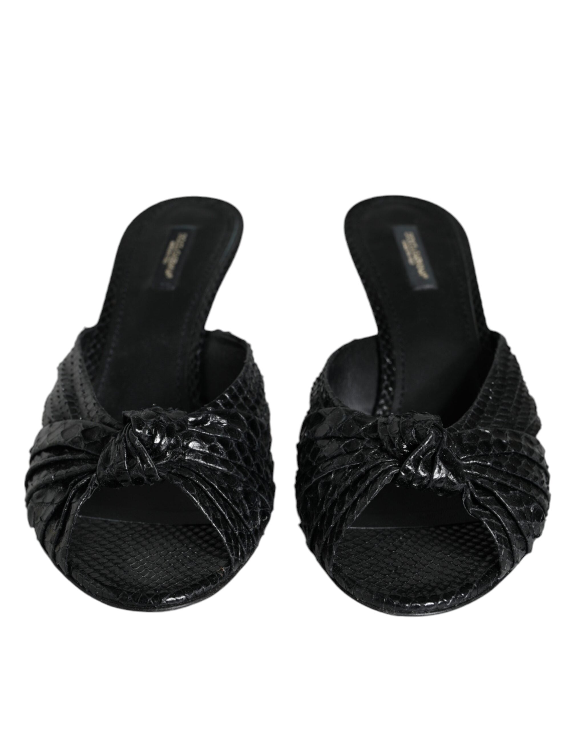 Black Dolce & Gabbana peep-toe slides in textured snakeskin leather with a knotted front detail and low heel.