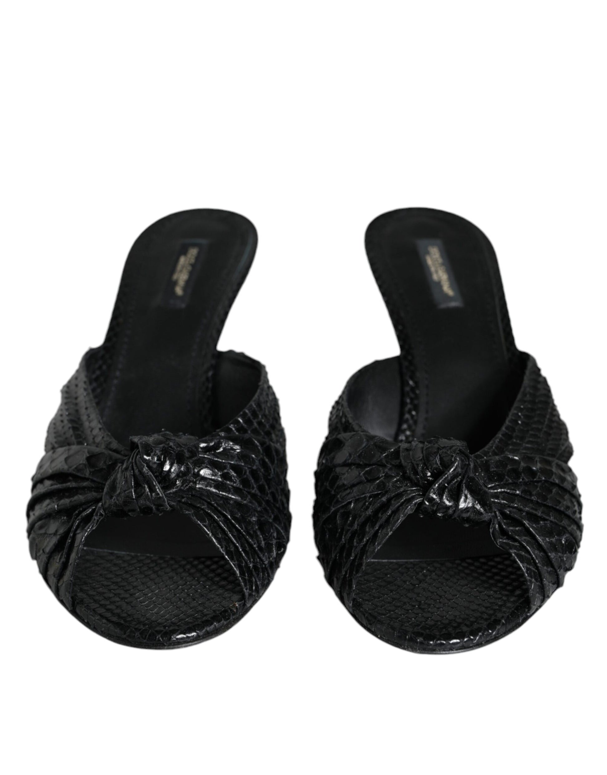 Black Dolce & Gabbana peep-toe slides in textured snakeskin leather with a knotted front detail and low heel.