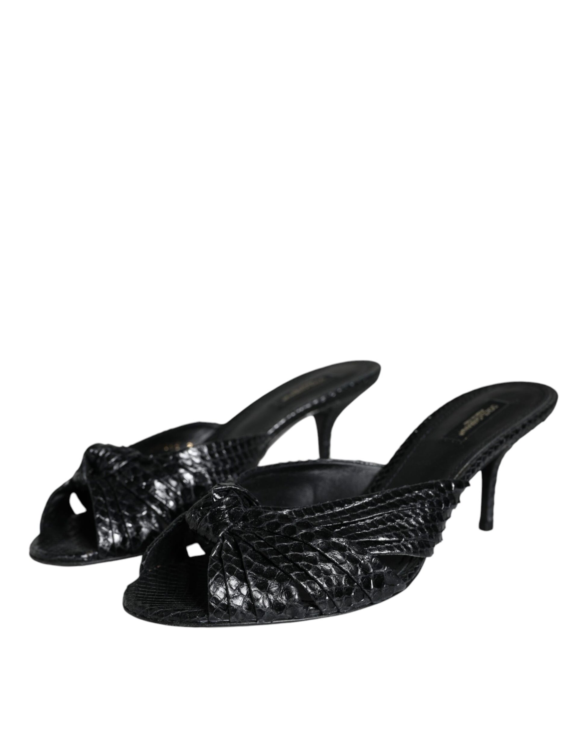 Dolce & Gabbana black snakeskin-textured leather slide heels with a knotted front and stiletto heel.