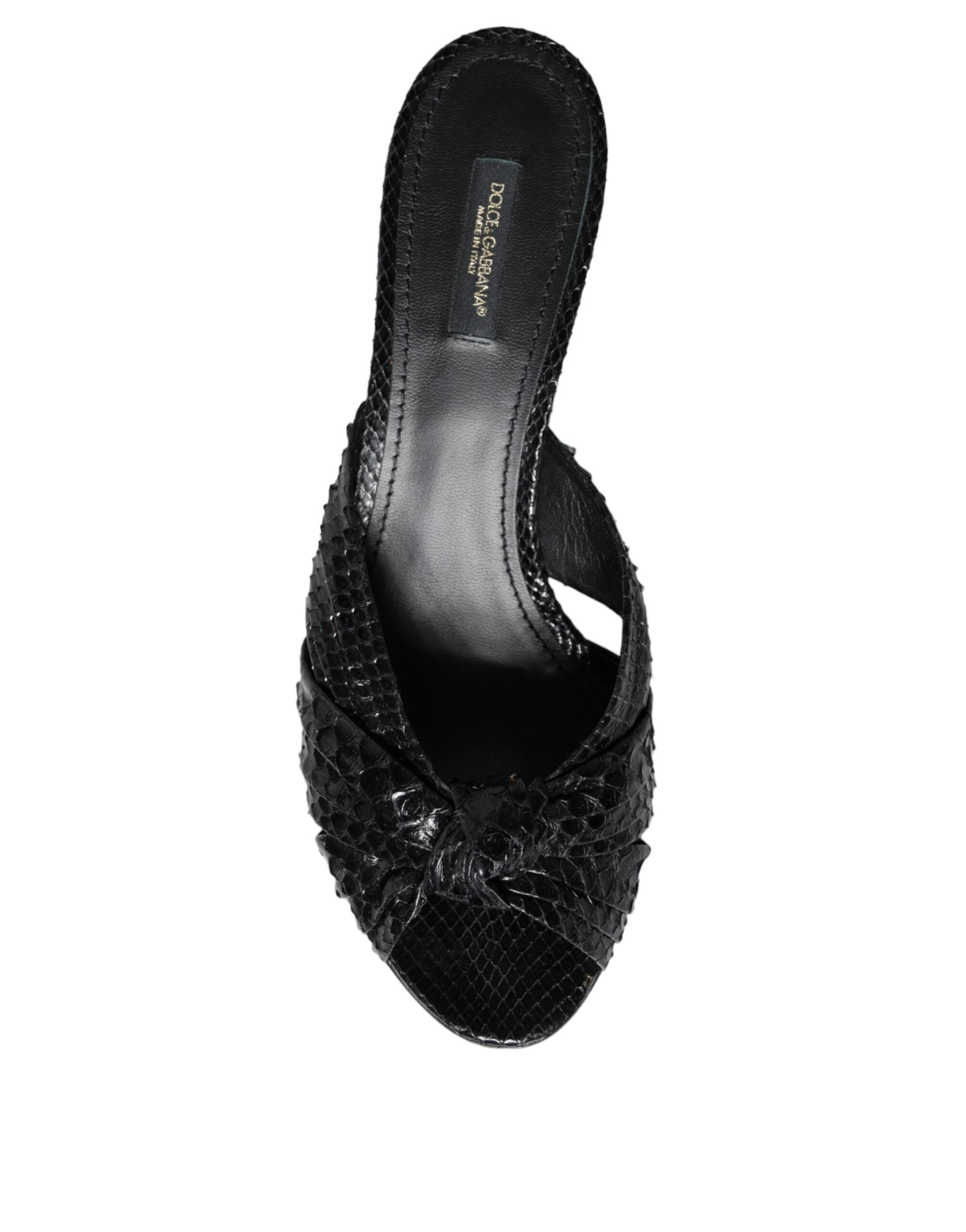 Dolce & Gabbana black snakeskin-embossed leather mule heels with a knotted front strap and open toe.