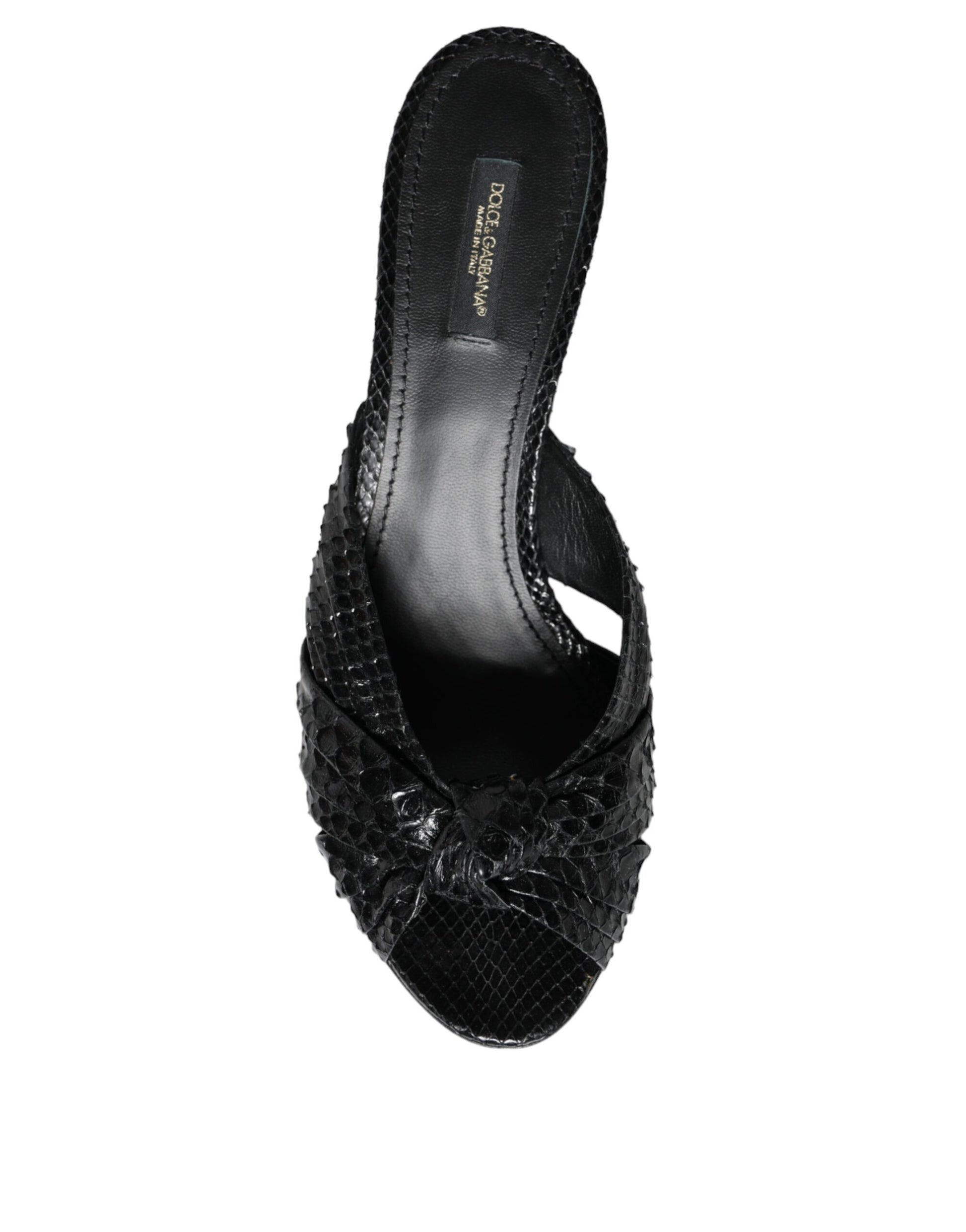 Dolce & Gabbana black snakeskin-embossed leather mule heels with a knotted front strap and open toe.