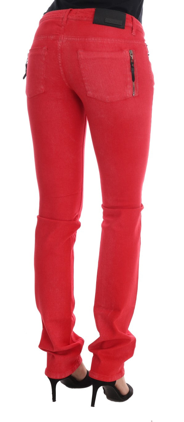 Back view of slim red cotton jeans with zip pockets worn with black heels